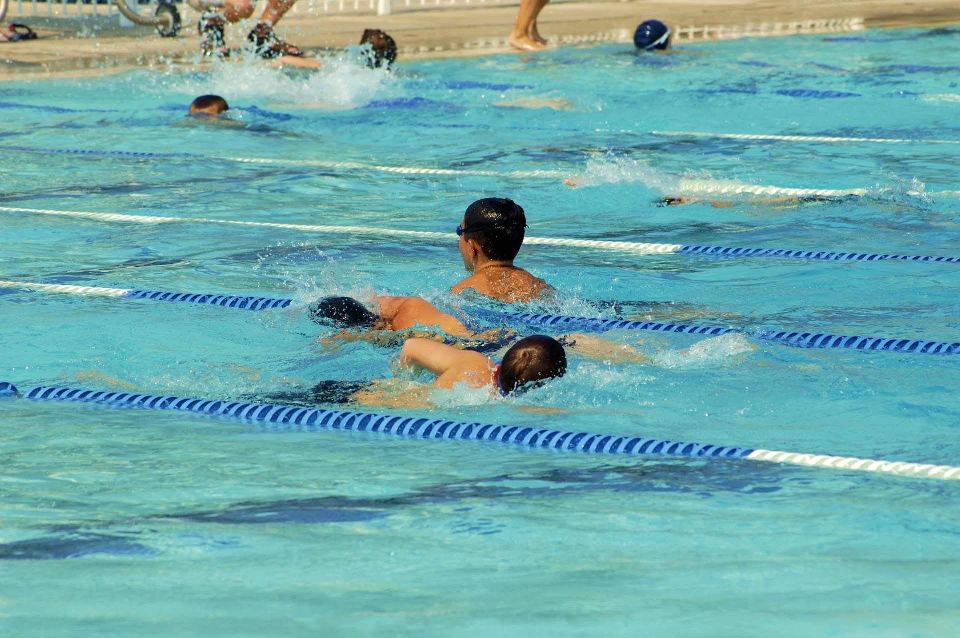 Several Kids Lap Swimming
